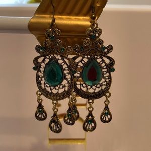 New Green Dangle earrings. One of the earring is missing a green gem stone.